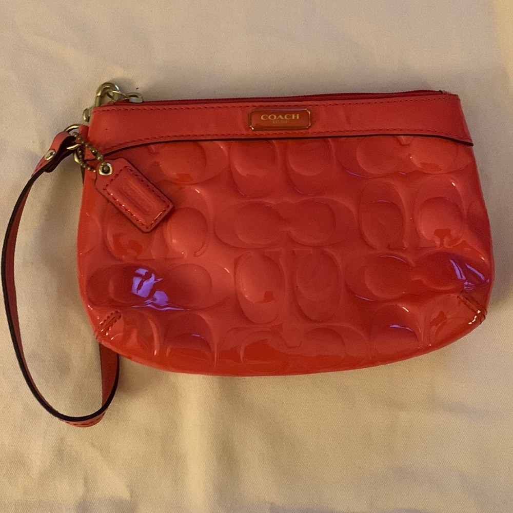 Orange patent leather coach wristlet